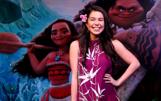 Auli'i Cravalho with Moana poster